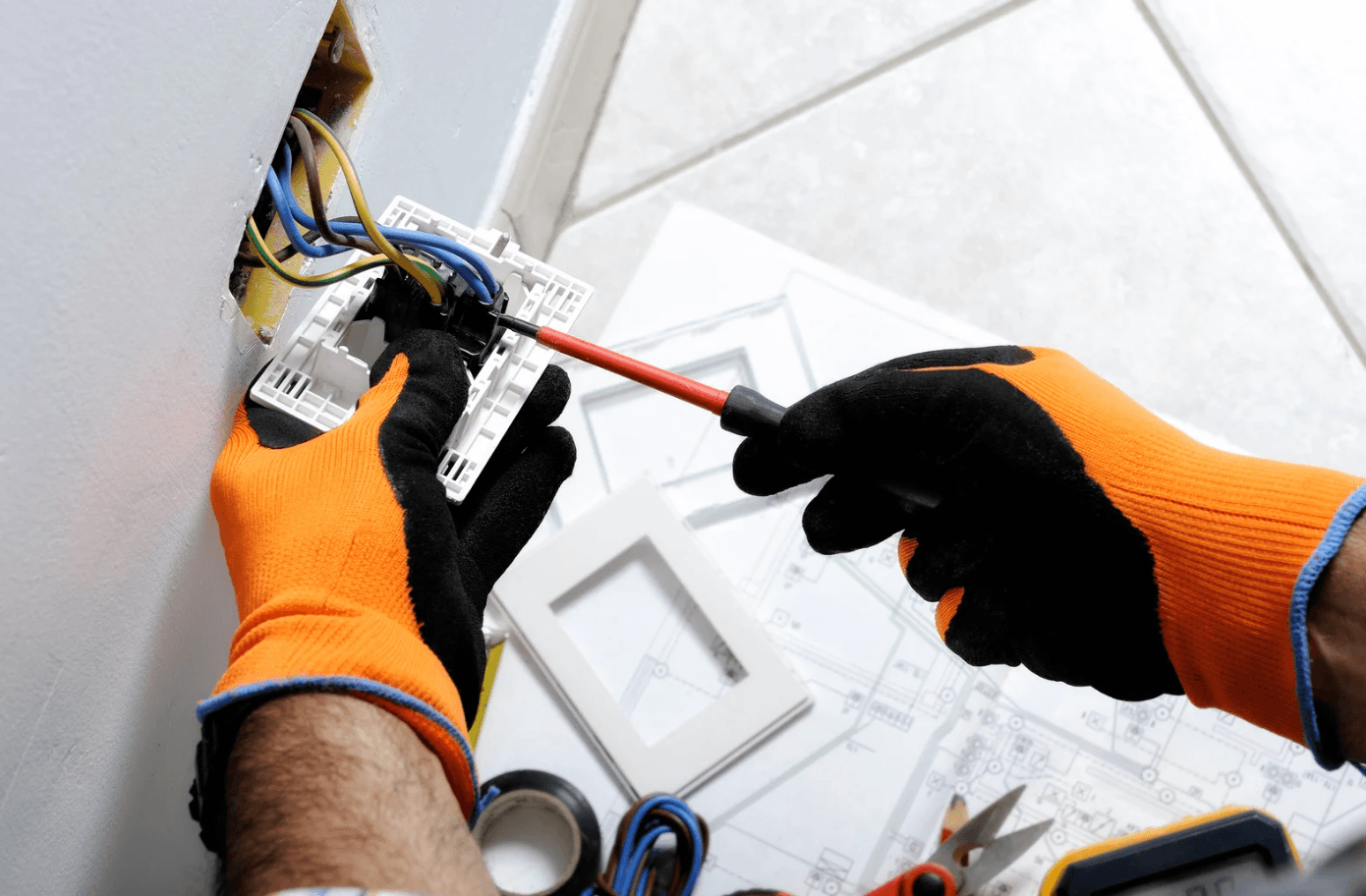 Gloved Electrician Wiring Receptacle